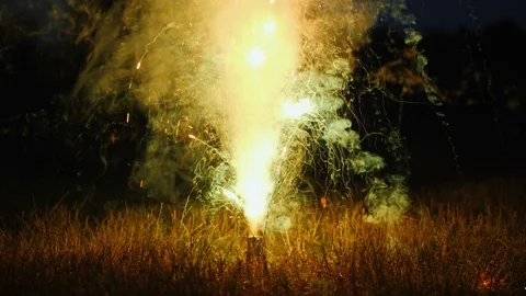 Fireworks on the dry grass. Dangerous behavior and cause of fire Stock Footage 117666801