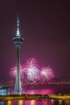 Fireworks explode above macau tower at night. Stock Photos
