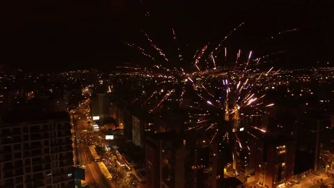 Fireworks Explode in front of a City Backdrop Stock Footage 74085284