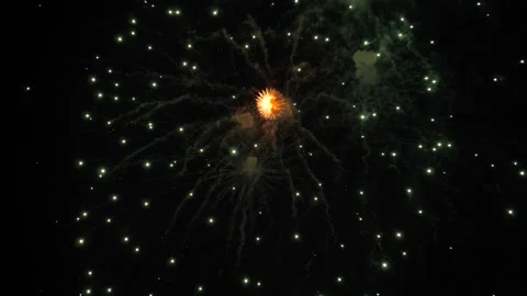 Fireworks explode leaving trails of shimmering stars in black sky at party Stock Footage 280347122