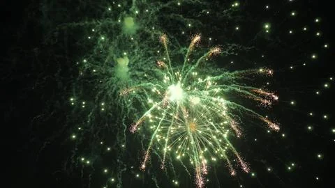 Fireworks explode leaving trails of shimmering stars in black sky at party Stock Photos