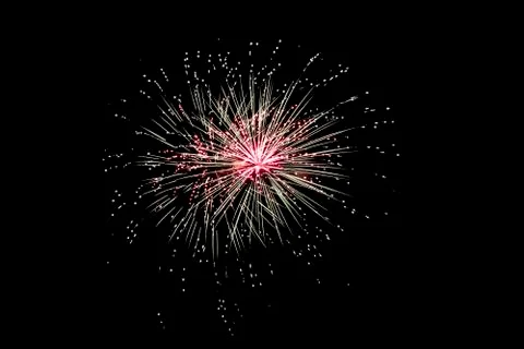 Fireworks explode at night Stock Photos
