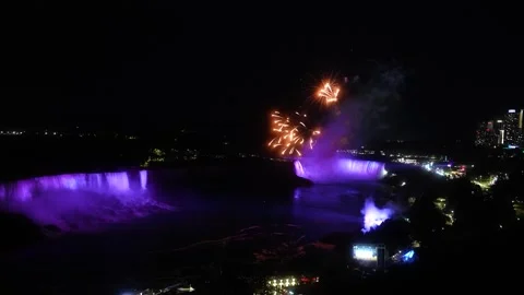 Fireworks Exploding Above Illuminated Niagara Falls at Night Stockbeeldmateriaal 347553195