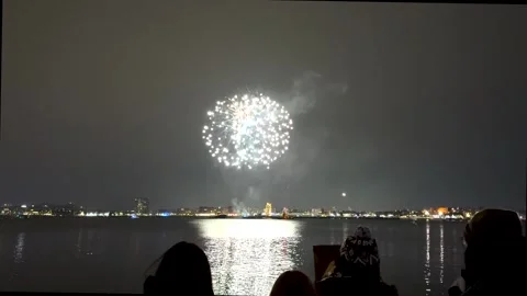 Fireworks exploding and reflecting over the waters of Boston Harbor Video stock 326370165