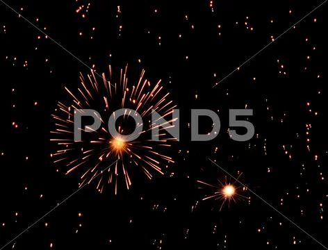 Fireworks exploding in black sky full of sparkles Stock Photos