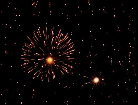 Fireworks exploding in black sky full of sparkles Stock Photos
