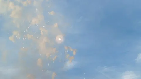Fireworks exploding in the clear blue sky in the daytime Stock Footage 278213991
