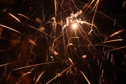 Fireworks exploding creating colorful light trails in the night sky Stock Photos