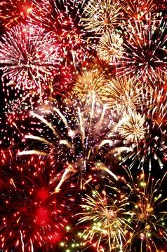 Fireworks exploding in the dark of the evening sky Stock Photos