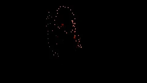 Fireworks exploding in a dark night sky resembling an elliptical circle design Stock Footage 318637121
