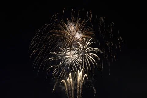 Fireworks exploding in the dark night sky during a celebration Stockfoto's
