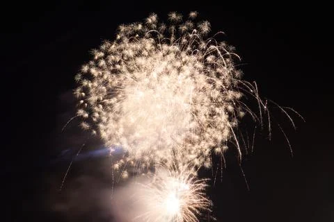 Fireworks exploding in the dark night sky during a celebration Stock Photos