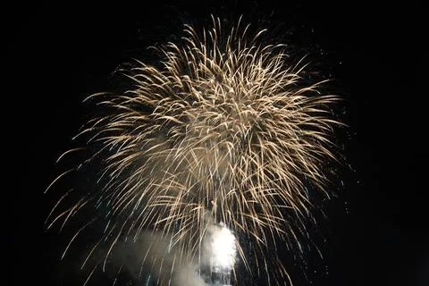 Fireworks exploding in the dark night sky during a celebration Stock Photos