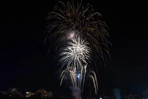 Fireworks exploding in the dark night sky during a celebration Stock Photos