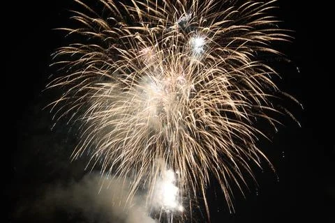 Fireworks exploding in the dark night sky during a celebration Stock Photos
