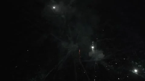 Fireworks exploding in the night sky with bright trails and bursts of light Stock Footage 296418460