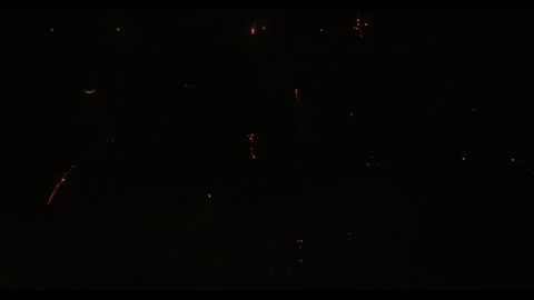 Fireworks exploding in night sky with crescent moon, no people Video stock 329774082