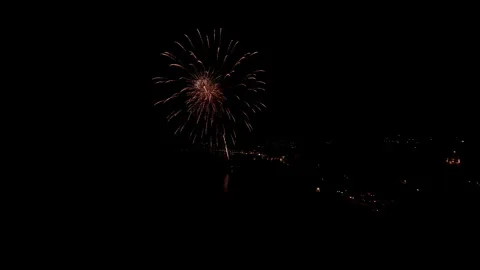 Fireworks exploding in the night sky over a city, creating a festive Stock Footage 282243822