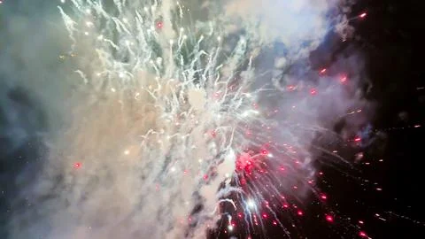 Fireworks Exploding in Night Sky with Smoke and DJ flicker lights 스톡 사진