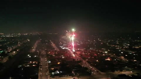 Fireworks Exploding over City Streets in the Evening with Bright Lights Stock Footage 150926152