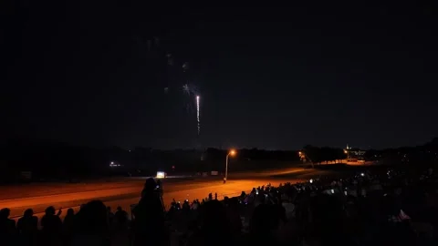 Fireworks exploding over a crowd at night 動画素材 340942011