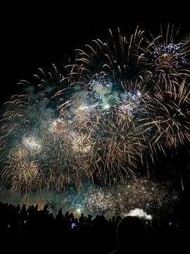 Fireworks exploding over crowd silhouettes at 22 July Cannes Stock Photos