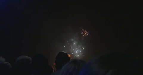 Fireworks exploding over heads of crowd (4K) Stock Footage 98665591