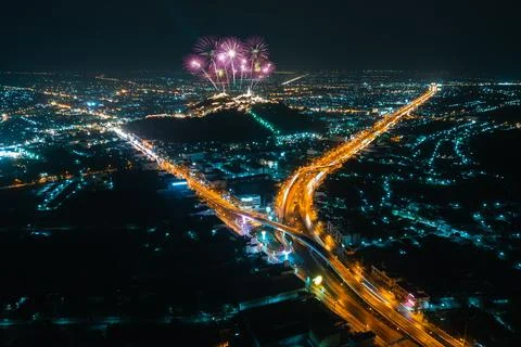 Fireworks Exploding Over Hilltop Temple Above Urban Highway Intersection Hi.. 库存照片