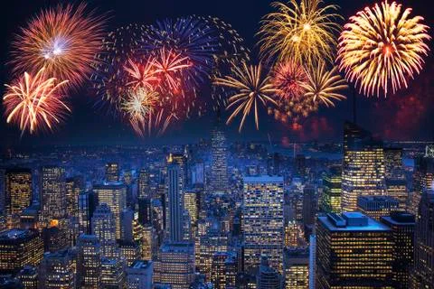 Fireworks exploding over illuminated cityscape, New York, New York, United Stock Photos