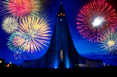 Fireworks exploding over monument in night sky, Reykjavik, Hofudborgarsvaedi, Stock Photos