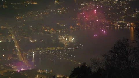 Fireworks exploding over night city New Years Eve tight close up Stock Footage 336201183