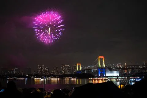 Fireworks exploding over Rainbow Bridge and Tokyo skyline at night Stock Photos