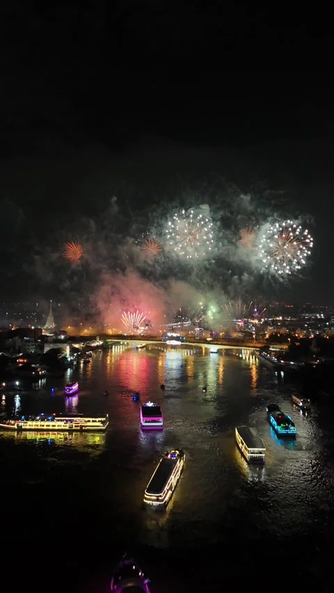 Fireworks Exploding Over River in Bangkok, Thailand with Illuminated Boats Stock Footage 335970138