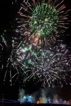 Fireworks exploding over streetlights on a bridge Stock Photos