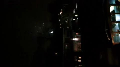 Fireworks Exploding In Sky Beside Building At Night. Vertical Video Stock Footage 169213245