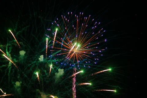 Fireworks explosion at night sky background. Holiday bright salute Stock Photos