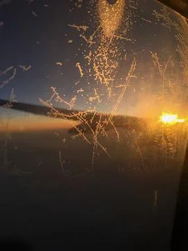 Fireworks explosion over water with bright sparks at sunset Stock Photos