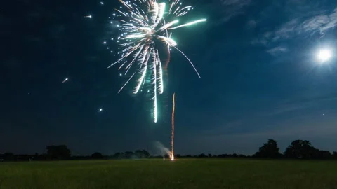 Fireworks in a field with the moon Video stock 154919598