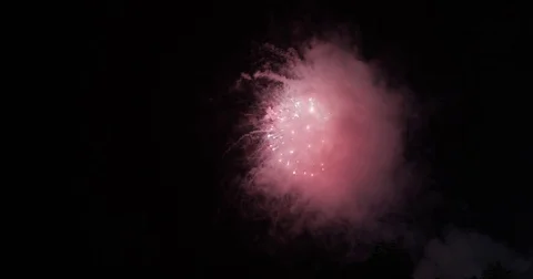Fireworks going off over black night sky Stock Footage 78887439