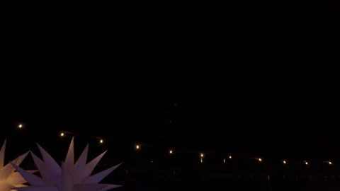 Fireworks light up the dark black sky with festoon and star lights in the Stock Footage 320467527