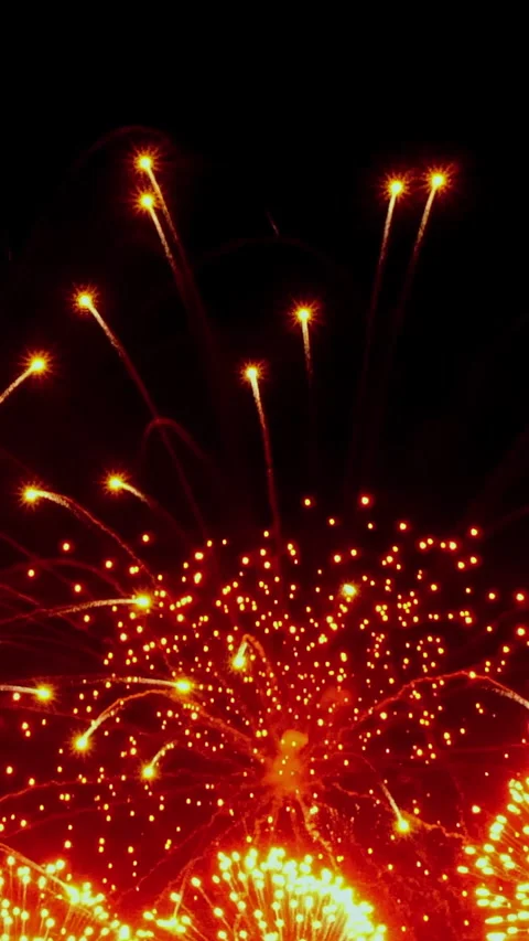 Fireworks light up the night sky over the city skyline in celebration Stock Footage 334920897