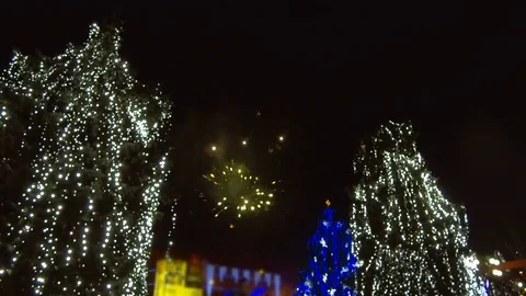 Fireworks light up sky over city. Holidays, celebrating New Year. Stock Footage 84088058