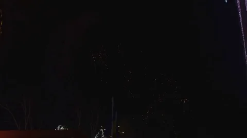 Fireworks light up sky over city. Holidays, celebrating New Year. Stock Footage 84088110