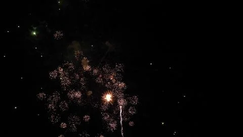 Fireworks magic creates shimmering trace ornaments in black night sky Stock Photos