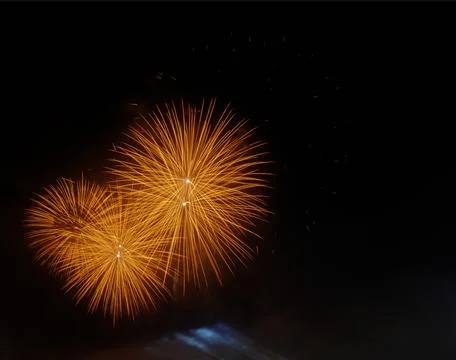 Fireworks with multiple explosions in the orange sky Stock Photos