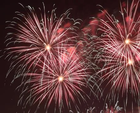 Fireworks - red fireworks exploding against dark night sky in a Stock Photos