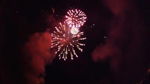 Fireworks rockets shoot up from lower frame and burst overhead Stock Footage 59516108