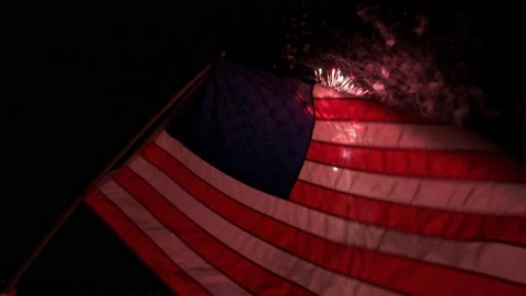 Fireworks showing though American Flag, Florida Keys Stock Footage 157239877
