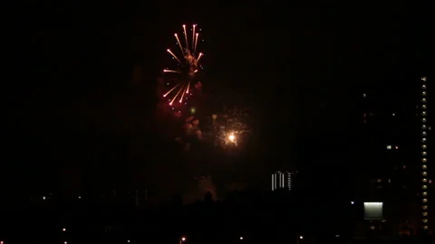 Fireworks in sky between city lights Stock Footage 148497568