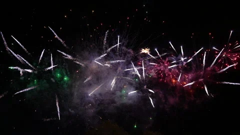 Fireworks with tails explode across the screen left to right twice Video stock 235020812